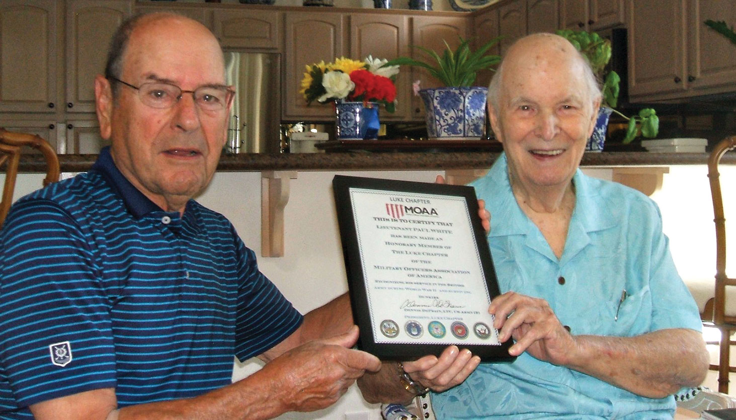 Captain Bob Cowan, U.S. Navy retired, presents Paul White a certificate of membership in the Luke Chapter of MOAA.