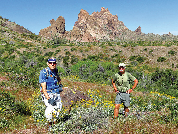 Lynn Warren (photographer, left) and Dave “Ausy” Ausman demonstrate social distancing while pausing for a photo with impressive Eagletail Peak in the background.