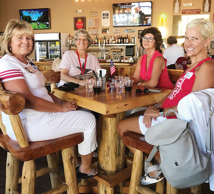 Nancy Moore, Cindy Zaklan, Jodie Heinz, and Cindy Finnegan seated at one of the many high tops in the pub.
