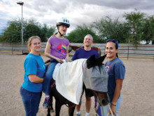 Katelyn Parmenter enjoys horse therapy with her parents, Lisa and Mark Parmenter, and special volunteer Christina.