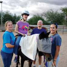 Katelyn Parmenter enjoys horse therapy with her parents, Lisa and Mark Parmenter, and special volunteer Christina.