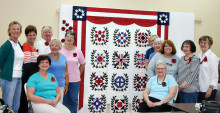 Placing of the finished blocks. From left back: Millissa Masters, Linda Labenz, Cathy Howell and Jean Fry; Seated: Cindy Santoro, Donna Wiznowski. From back right: Linda Shaver, Erma Taylor, Jackie Droncheff, Shirley Cushing and Jan Johnson; Seated Edna DeFord