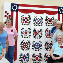 Placing of the finished blocks. From left back: Millissa Masters, Linda Labenz, Cathy Howell and Jean Fry; Seated: Cindy Santoro, Donna Wiznowski. From back right: Linda Shaver, Erma Taylor, Jackie Droncheff, Shirley Cushing and Jan Johnson; Seated Edna DeFord
