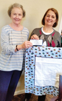 Johanna Kaufman and Donna Aybar with a charity receiving blanket.