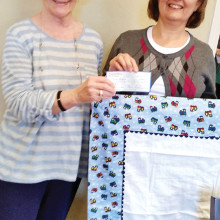 Johanna Kaufman and Donna Aybar with a charity receiving blanket.