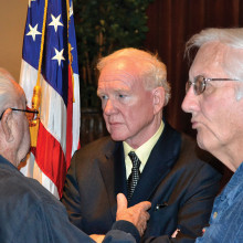 Donald Critchlow, center, meeting with members after the program.