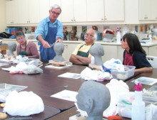 Students pay close attention to sculpting instructions by Ross Hart.