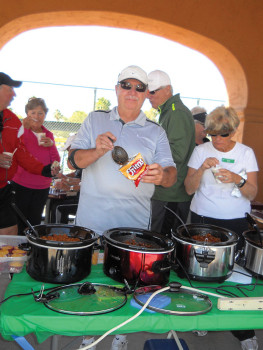 Ken Prom, who came in second in the chili competition, makes a Fritos pie with his Authentic Southern Hospitality Chili.