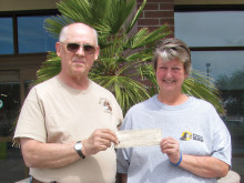 Jim Ellison presents check to Pam Boren.