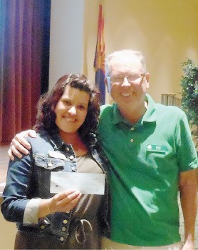 Karen Ragoza accepts a check from Rob Risden on behalf of The New Life Center.