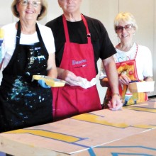 Artists Judy Hale, Duane Langston and Alla Langston paint the set pieces for A Night at the Renaissance.