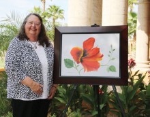 Nancy Hampton displays her canvas Hisbiscus Red.