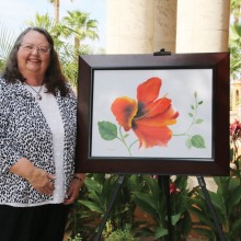 Nancy Hampton displays her canvas Hisbiscus Red.