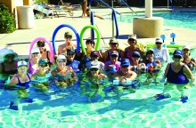 Some of the participants from Water Fitness class gather wearing their favorite team hats and visors at the Tuscany Falls Pool.