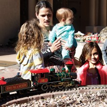 PebbleCreek residents Donnie and Linda Renfro’s daughter-in-law Jill shows her girls (Addi, Rori and Jada) the Christmas special as it rounds one of the planters in the courtyard!