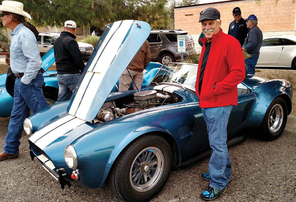 Wally Zink admiring a Shelby Cobra at the Toys for Tots car show in Wickenburg