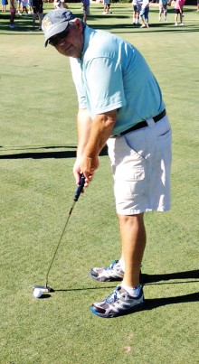 Cliff Olson lines up his putting shot.