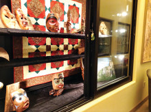 PebbleCreek Woodcarvers Club display of recently carved masks in the Creative Arts Center; backdrop was supplied by the PebbleCreek Quilters.