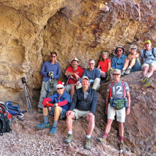Left to right, front: Lynn Warren (photographer), Tom Wellman, Gary Bray; rear: Mark Frumkin, Steve Duncanson, Les Reister, Nancy Love, Jim Gillespie, Julie Walmsley and Clare Bangs sheltered from a cool breeze by a large overhang next to the double arches.