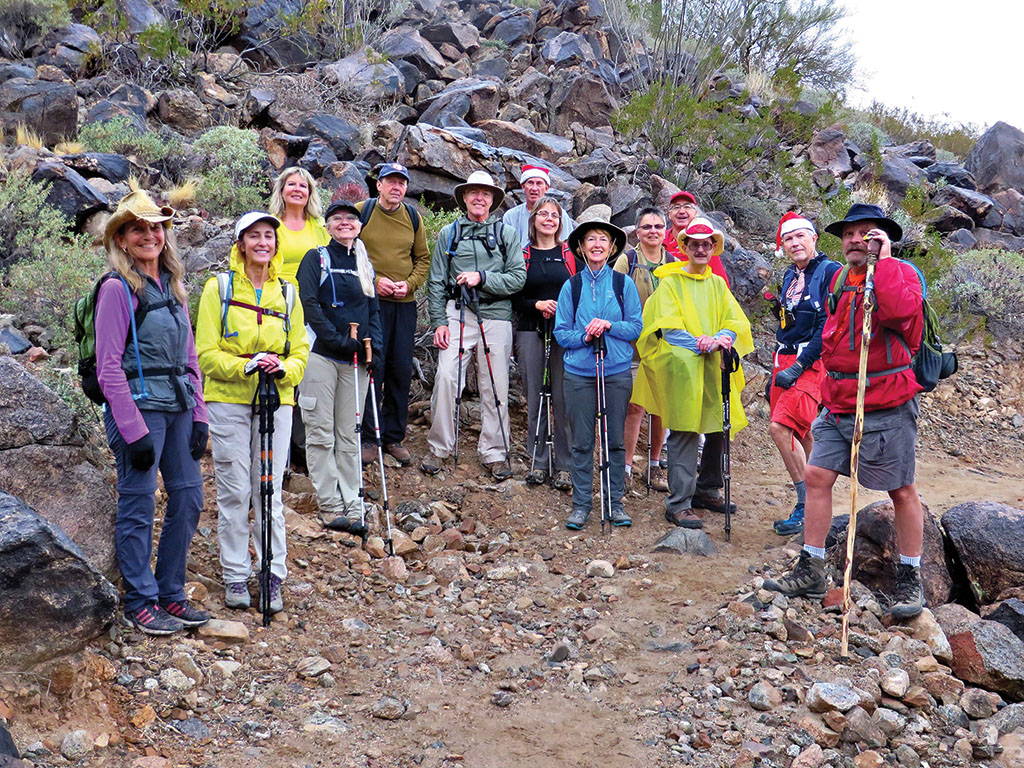 Left to right: Marilyn Reynolds, Sandy Mednick, Charlene Elijew, Len Jeffery (guest), Dana Thomas, Clare Bangs, Kay Thomas, Ann Rohlman, Diana Bedwell, Wayne Wills, Pete Williams, Lynn Warren (photographer) and Alex Elijew combined B and C hikers on the trail at Sunrise Mountain.