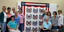 The quilts at the Arizona Quilters Guild Show with winning ribbons