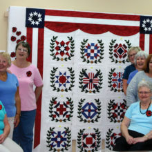 The quilts at the Arizona Quilters Guild Show with winning ribbons