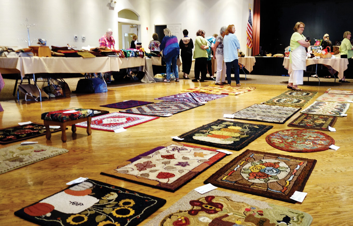 Display of hand hooked rugs at Hook-In