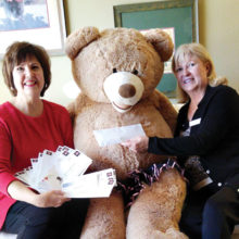 Mary Couzens (left) presents a contribution from Mary Couzens Realty Fun for Charity Concerts to the Kare Bears’ Bear and Corrine Adams, a Kare Bear volunteer!