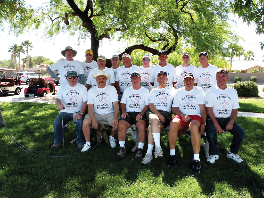 Showing off their new shirts emblazoned with All-America HorseShoe Association are, front row, from left: Jim Sulzer, Bob Ewest, Ted Ingalls, Paul Messina, Tom Bose and Frank Glowinski; back row: Doug Rollins, Steve Gramm, Doug Will, Jim Loeb, Bernie Babcock, Rich Tighe, Jeff Harper, Elliott Rudoy and Tim Irvin. Absent from the photo are regulars Ron Glynn, Vern Henrickson, Patricia Ingalls, Dave Kauchek, Ken Kopps, John McSwiggan, John Mitchell, Dick Oliver and Georgia Weinstein; photo by Paul Messina.
