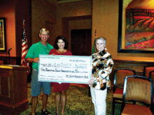 John Pugsley, the president of the Irish American Club, Corine Raygoza, the director of the New Life Center and Ellen Jacob, the chairman of the PCIAC Charitable Contribution Committee. The Irish American Club has three purposes, education, social and charity.