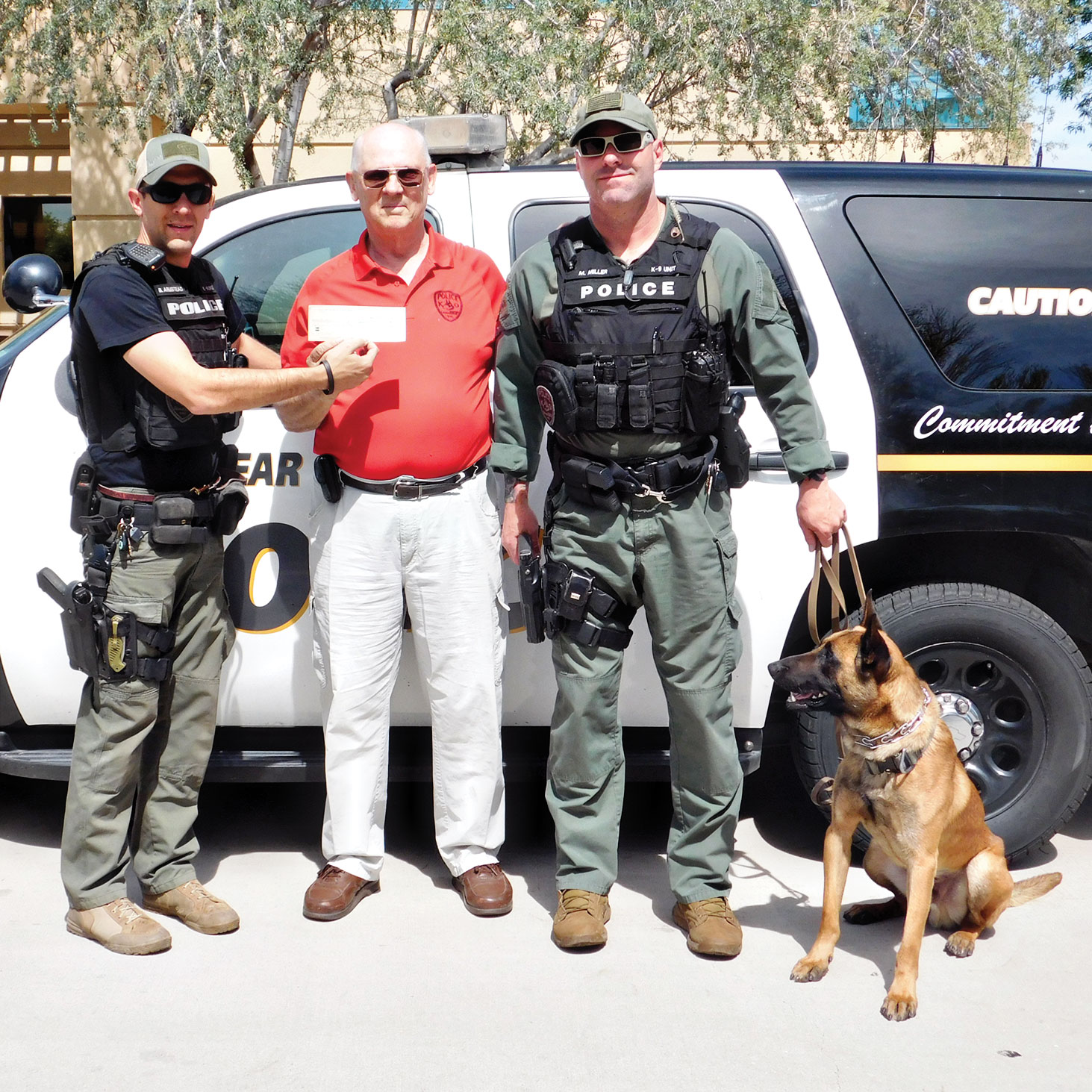 Left to right: K-9 Officer Ben Armstead, Pet Companions Club President Jim Ellison and K-9 Officer Mike Miller with  his canine partner Toby