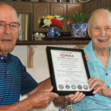 Captain Bob Cowan, U.S. Navy retired, presents Paul White a certificate of membership in the Luke Chapter of MOAA.
