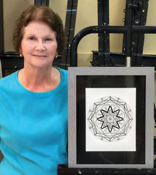 Judy Stough with one of her Mandala creations.