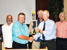 Incoming PCSSA President Steve Ward presenting first place trophy to Jack Hogan (Team Manager) accepting for Augies. Augies players in background are Tom Petrizzio, Terry Ranta and Josh Rabinowitz