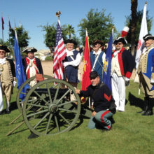 Arizona Sons of the American Revolution led in PebbleCreek by homeowner Matt Scott (first from left) gather around a cannon owned by PebbleCreek resident Todd Smith (front), after PebbleCreek’s commemoration of Armed Forces Day.