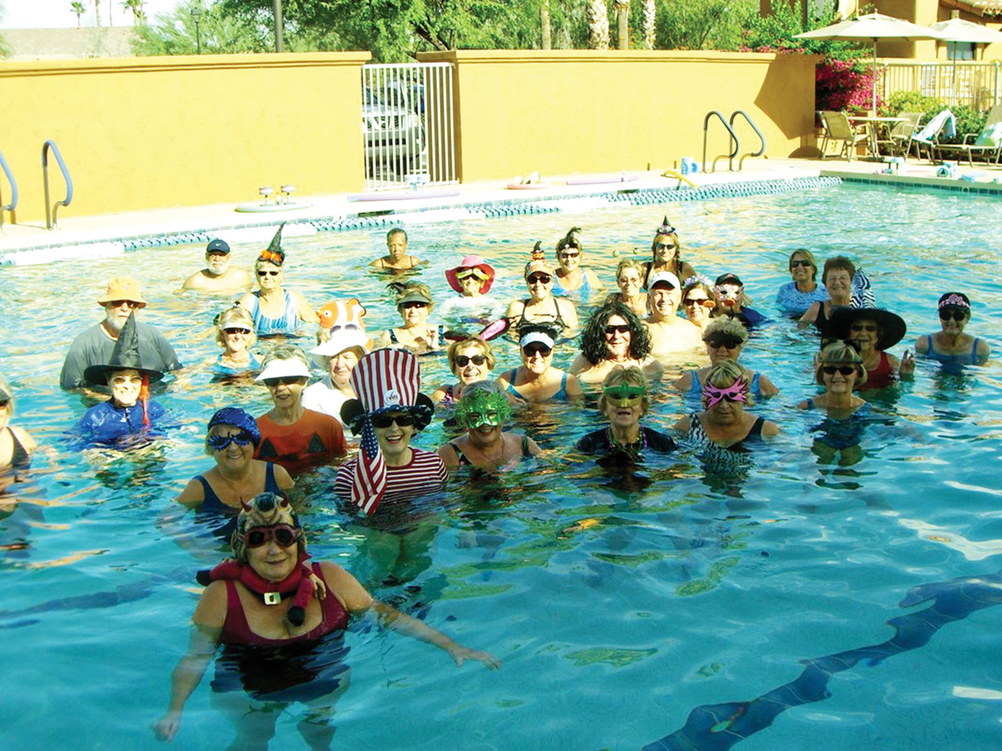 The Water Fitness class celebrated Halloween by dressing in waterproof masks and hats.