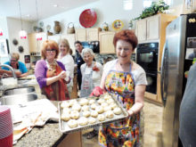 Hermine Sulzberg holding the knishes yet to be baked from those who participated in her Knish Klass