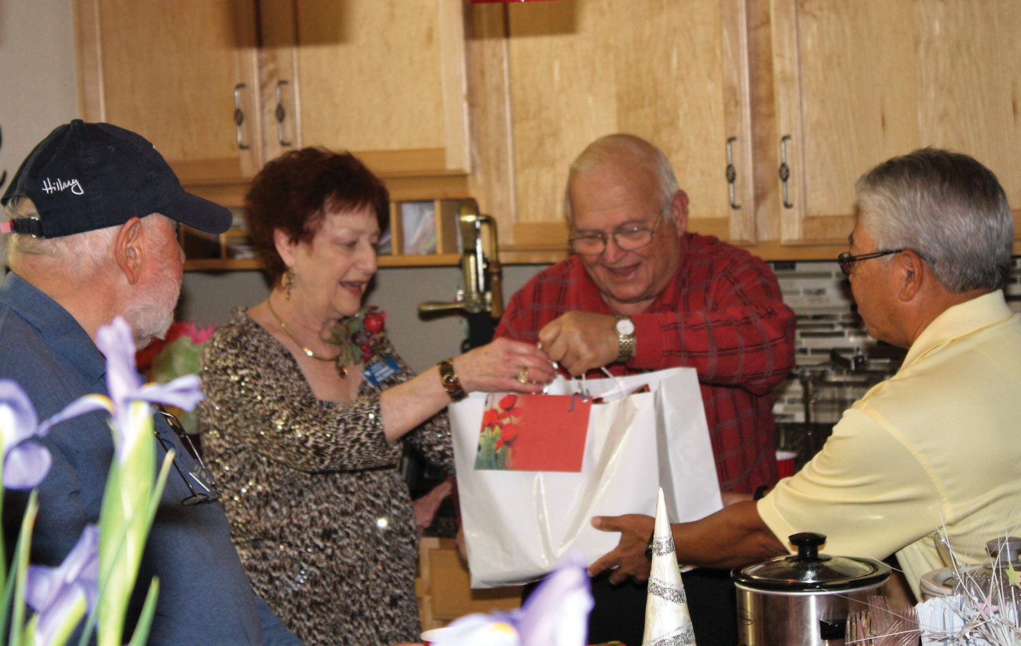 Members of the PebbleCreek Car Club enjoy a lively gift exchange at their annual holiday party.