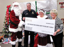 Left to right: Santa Claus, Chief Jerry Geier, Mrs. Claus and Wally Campbell, Chairman of PebbleCreek Home Tour Committee