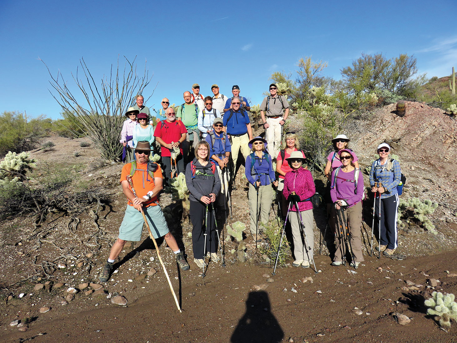 Front, left to right: Nancy Love (hike leader), Jeanette Wellman, Hal King, Sandy Mednick, Debbie Barbe, Linda Vaughn, Kristine Hanlon, Cathy Wills, Art Solorio, Tom Lenertz (guest); back: Lynn Warren, Bob Lenertz, Marty Gilligan (guest), Tom Wellman, Wayne McKinney, Kay Thomas and Mike McEvilly enjoying the morning sun in front of the Stone Throne; photo by Doug Jamiolkowski.