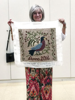 Sheila Millendorf proudly displays her first project.