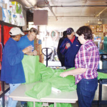 Community Church members and friends fill dinner bags from the Agua Fria Food Bank’s inventory.