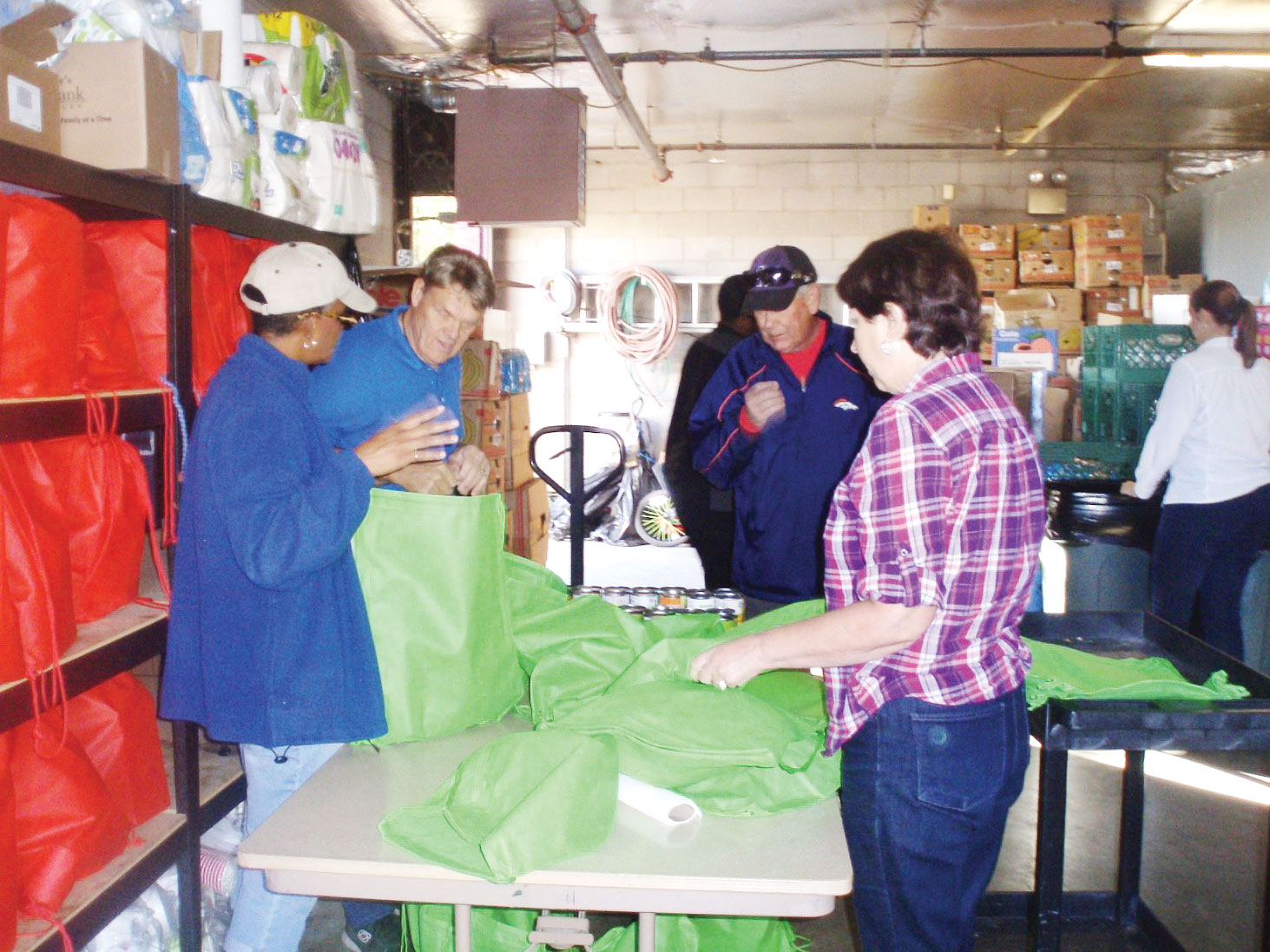 Community Church members and friends fill dinner bags from the Agua Fria Food Bank’s inventory.