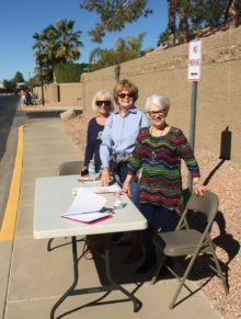 Left to right: Arlis Legler, the chair for distribution of the PebbleCreek Source Books, is pictured with volunteers Sherry Atwater and Laura Measles as they distribute Source Books to delivery volunteers.