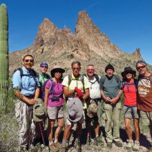 Left to right: Ed Kim, Lynn Warren (photographer), Beverly Kim, Mark Frumkin, Mark Gruca, Len Jeffery, Vicki Carter and Gary Bray pausing shortly after lunch with Eagletail Peak in the background.