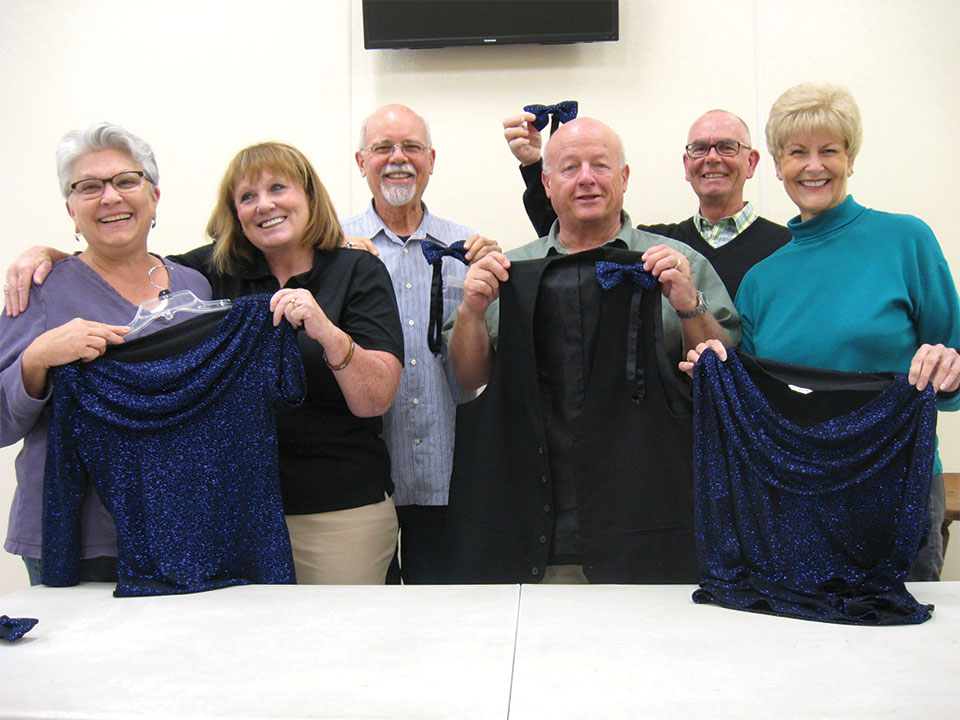 PC Singers welcomes six new members to the 2016-2017 concert season. Checking their costumes (left to right) are Gloria Lloyd, Sheila Snyder, Jerry Drake, Doug Will, Cliff Mercer and Ann Abke