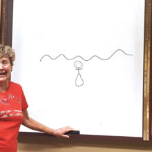 Patti Hodge sketches a mermaid for Pictionary; photo by Shawnee Robison.