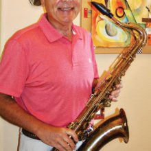 Jeff Buda at his PebbleCreek home with his saxophone