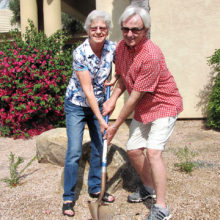 Monarch advocates Flora Conley and Ross Hart help plant milkweed in the Activities Center garden.