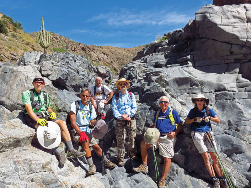 Left to right: Lynn Warren (photographer), Mark Frumkin, Clare Bangs, Pete Williams, Dennis Zigmunt and Susan Rudoy pause after lunch on giant boulders in the Agua Fria riverbed.